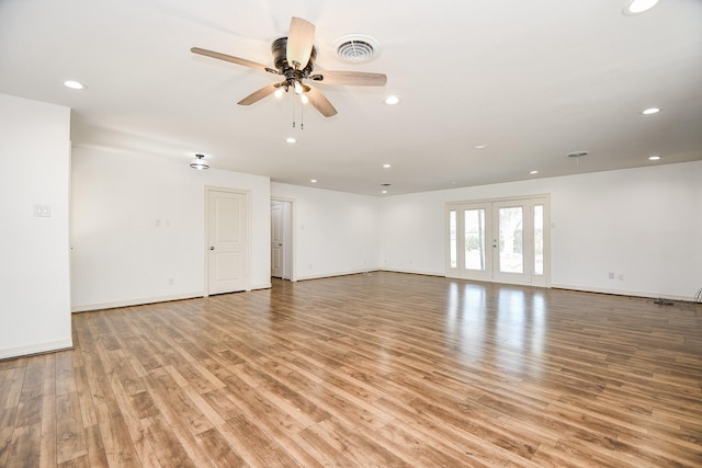 spare room featuring ceiling fan, light hardwood / wood-style floors, and french doors