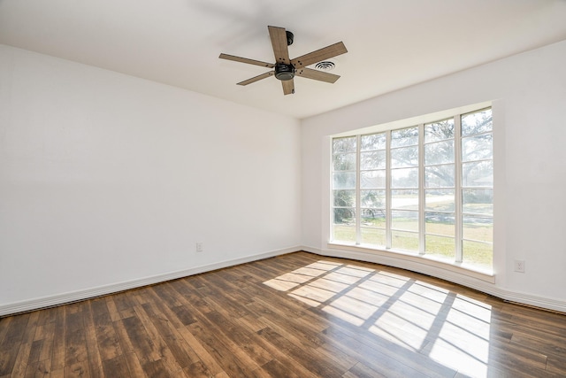 spare room with ceiling fan and dark hardwood / wood-style floors