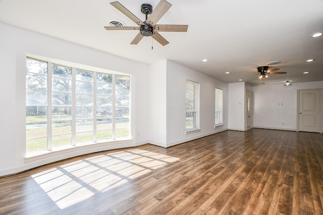 unfurnished living room with dark hardwood / wood-style floors and ceiling fan