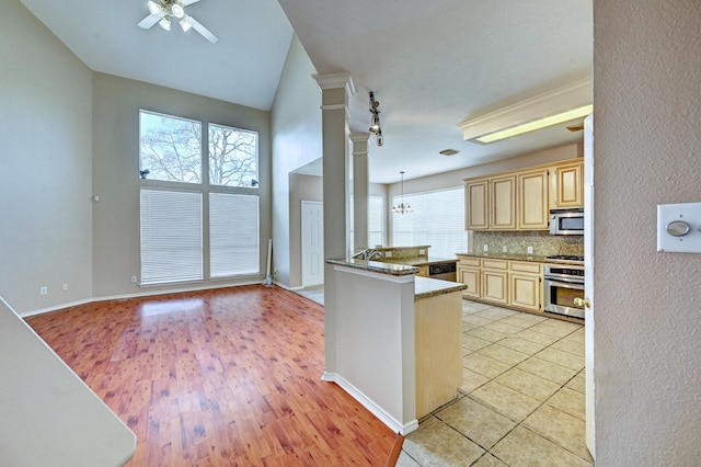 kitchen with appliances with stainless steel finishes, light brown cabinetry, decorative light fixtures, decorative columns, and kitchen peninsula