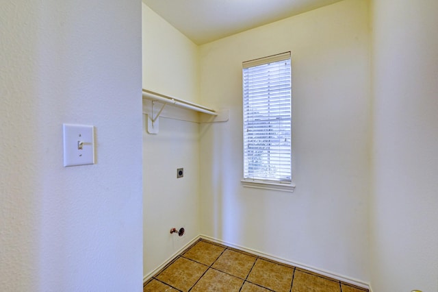 laundry room with gas dryer hookup, hookup for an electric dryer, and light tile patterned flooring