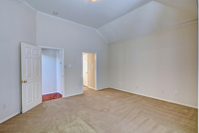 unfurnished bedroom with ornamental molding, vaulted ceiling, and light carpet