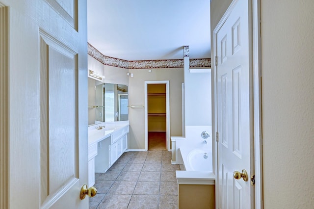 bathroom with tile patterned floors, vanity, and a bathing tub