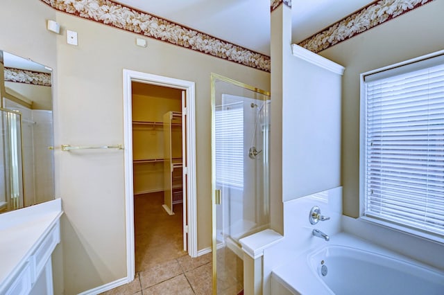 bathroom featuring tile patterned flooring, shower with separate bathtub, a healthy amount of sunlight, and vanity