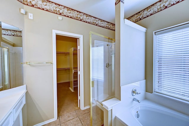 12726 Silverglen Estates Dr, Houston, TX 77014 - bathroom with a shower stall, tile patterned floors, a spacious closet, and a garden tub