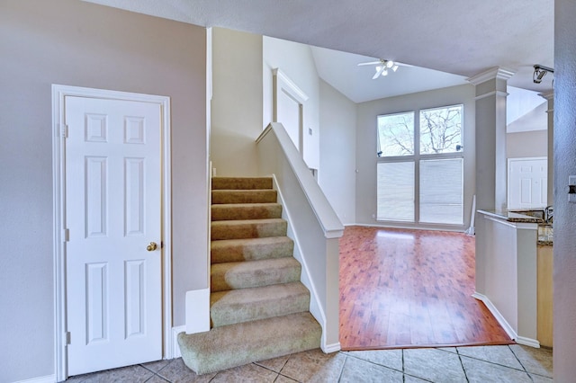 entryway featuring ceiling fan, decorative columns, and light tile patterned floors