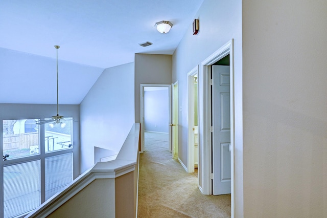 12726 Silverglen Estates Dr, Houston, TX 77014 - hall with light colored carpet, visible vents, an upstairs landing, lofted ceiling, and baseboards