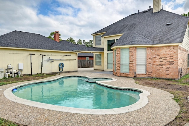 12726 Silverglen Estates Dr, Houston, TX 77014 - view of pool with a patio area, a pool with connected hot tub, and fence