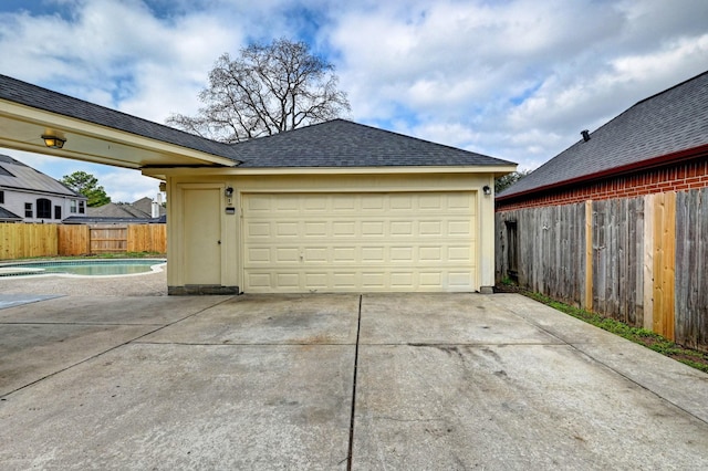 garage with a fenced in pool