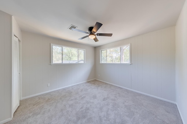 carpeted empty room with ceiling fan