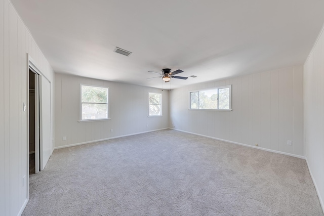 unfurnished bedroom featuring light carpet and ceiling fan