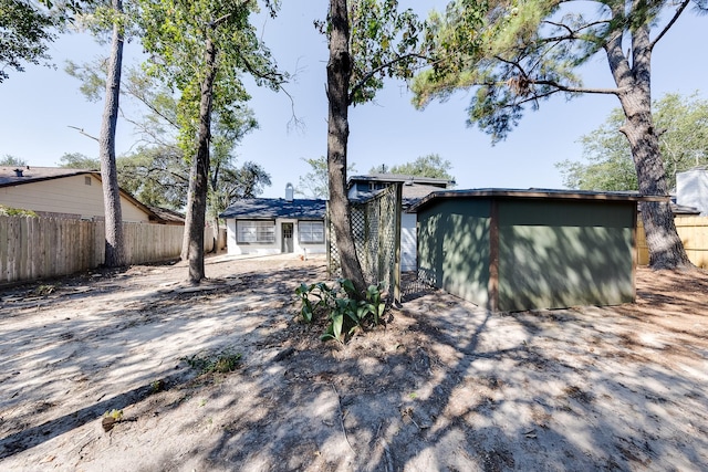 view of front of home featuring a storage shed