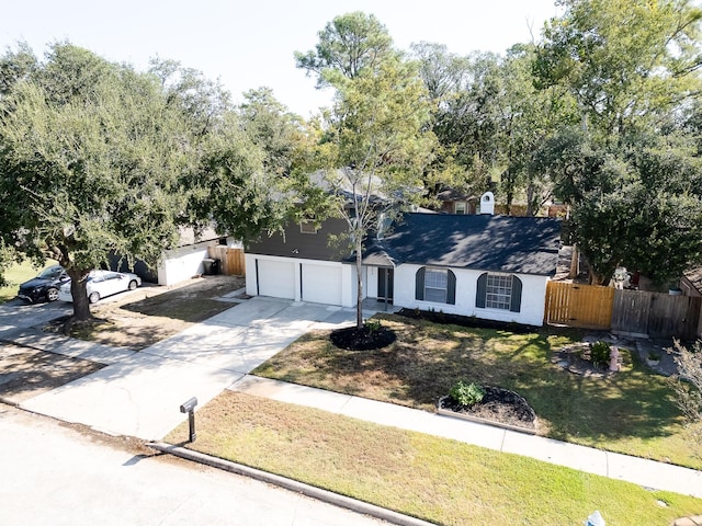 view of front of house with a garage and a front lawn