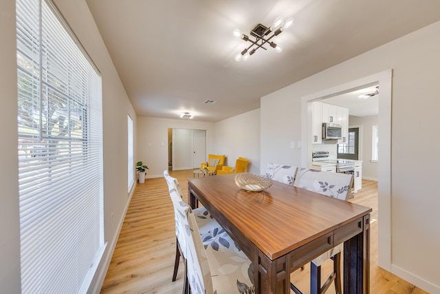 dining space with light hardwood / wood-style floors