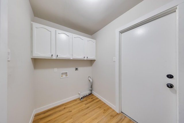 clothes washing area with gas dryer hookup, cabinets, light wood-type flooring, hookup for a washing machine, and electric dryer hookup