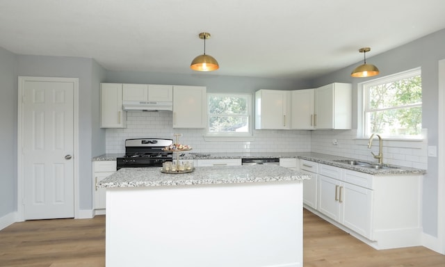 kitchen featuring hanging light fixtures, sink, white cabinets, and appliances with stainless steel finishes