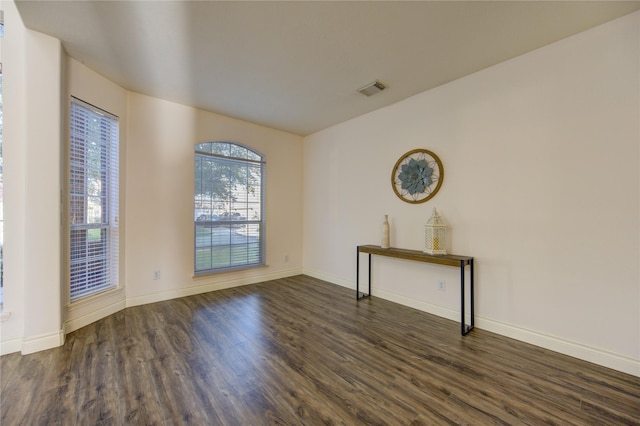 spare room with dark hardwood / wood-style floors