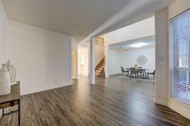 unfurnished living room with dark hardwood / wood-style floors