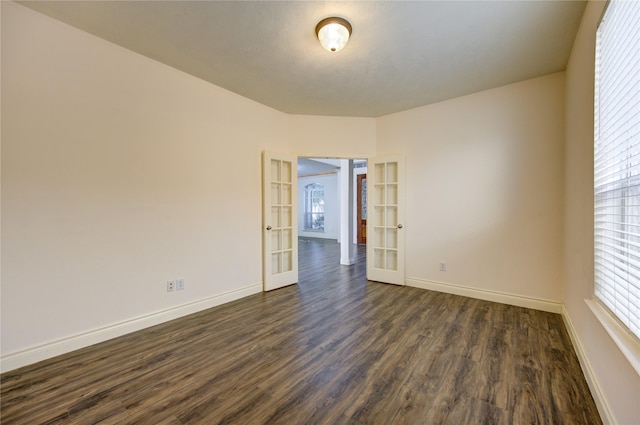 unfurnished room with dark hardwood / wood-style flooring and french doors