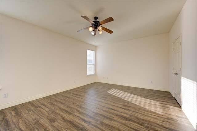 unfurnished room with ceiling fan and dark hardwood / wood-style flooring