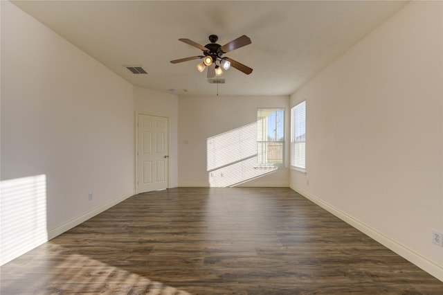 spare room featuring ceiling fan and dark hardwood / wood-style floors