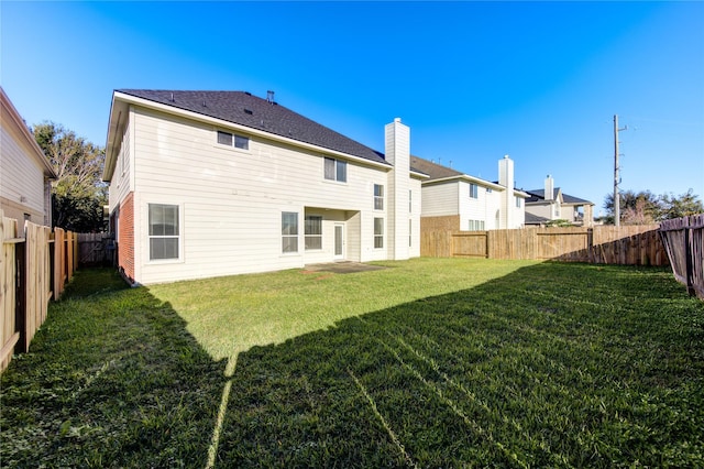 back of house with a yard