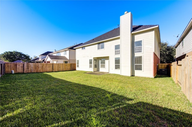 rear view of house with a yard