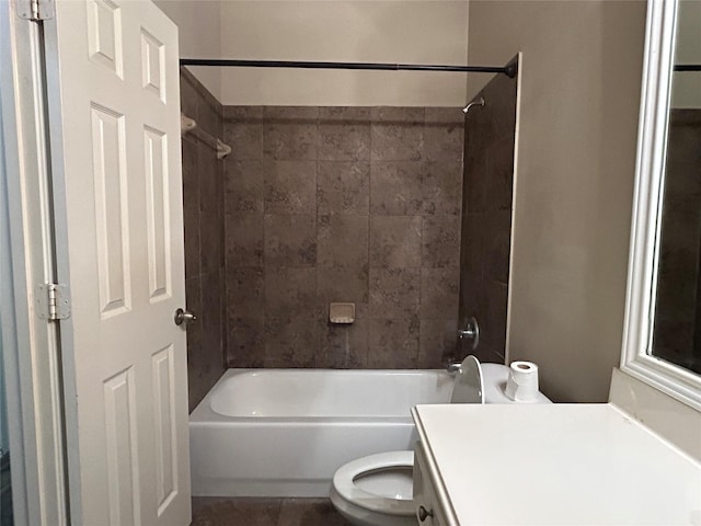 full bathroom with tiled shower / bath, vanity, and toilet