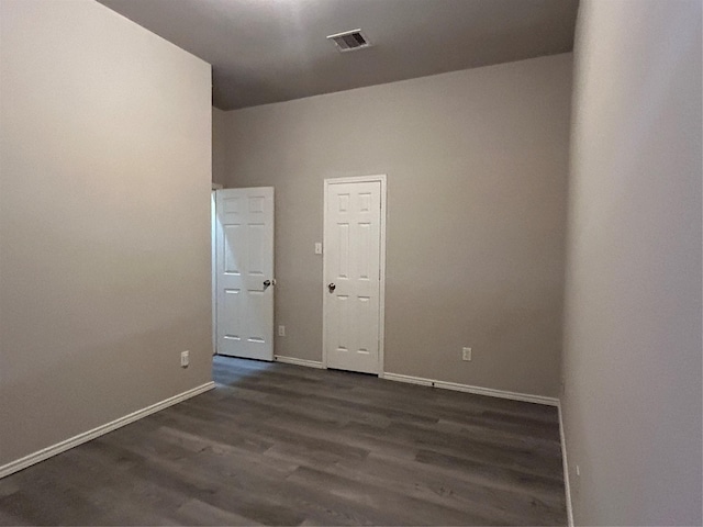 unfurnished room with dark hardwood / wood-style floors