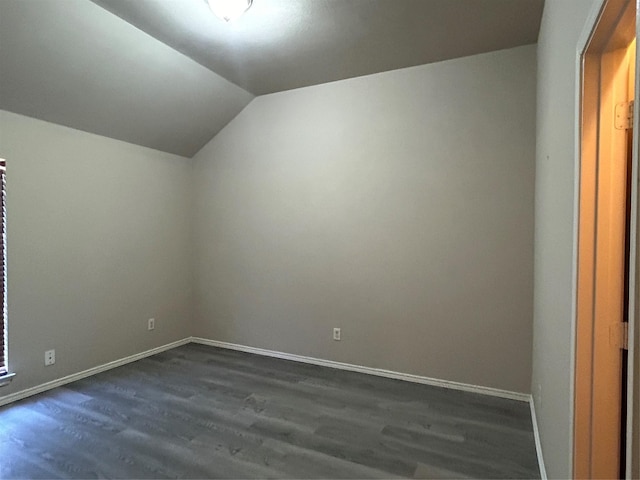 additional living space featuring lofted ceiling and dark hardwood / wood-style floors