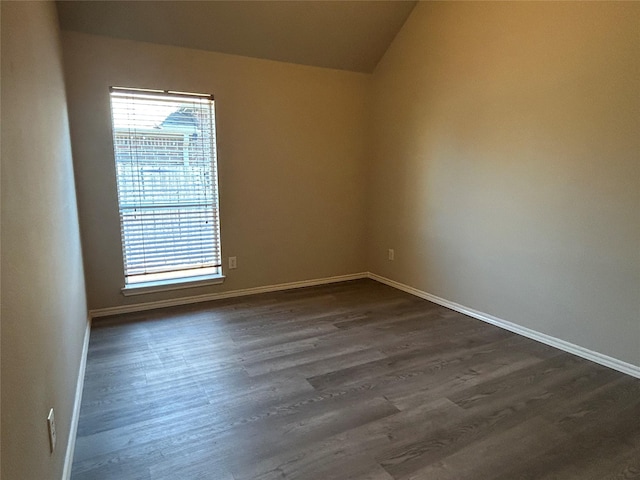 spare room with dark wood-type flooring