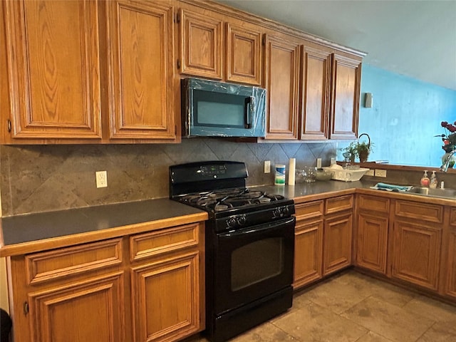 kitchen with backsplash, sink, and black gas stove