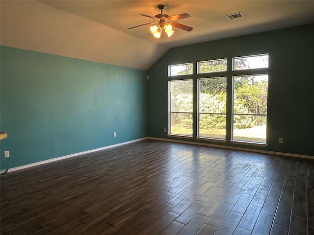 spare room featuring dark wood-type flooring, ceiling fan, and vaulted ceiling