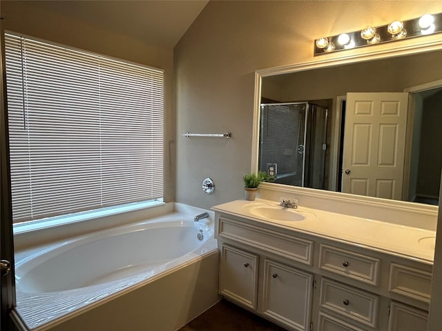 bathroom with independent shower and bath and vanity