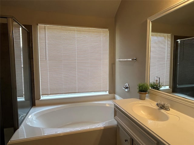 bathroom featuring vanity and separate shower and tub