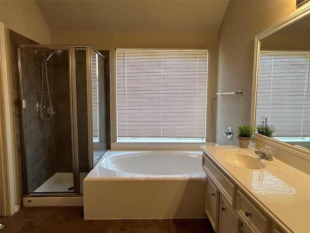 bathroom featuring vanity and independent shower and bath