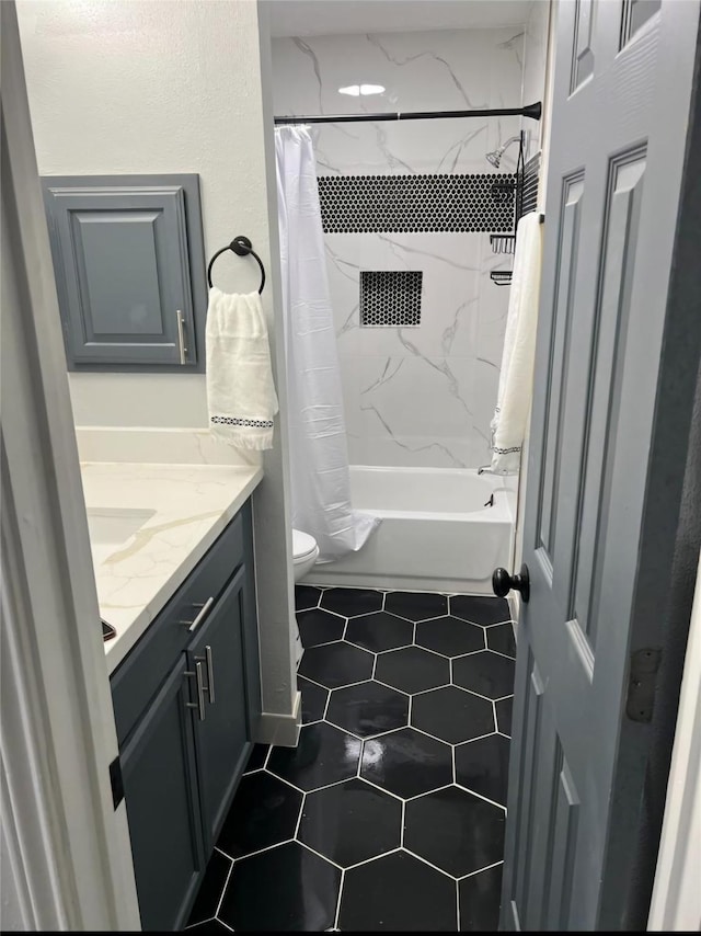 full bathroom featuring tile patterned floors, vanity, toilet, and shower / tub combo