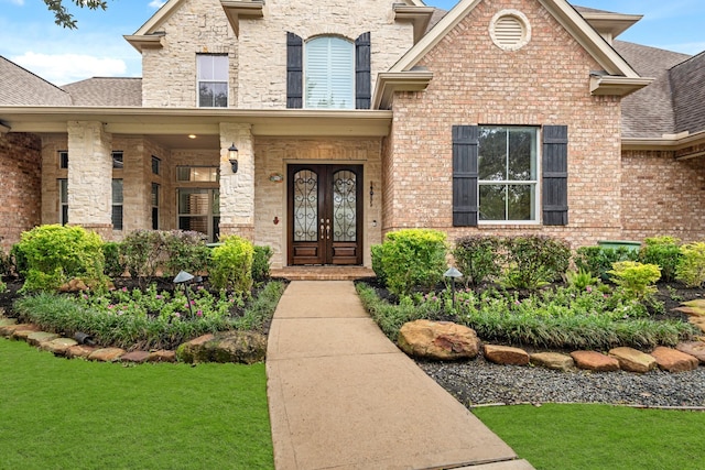 property entrance with a yard and french doors