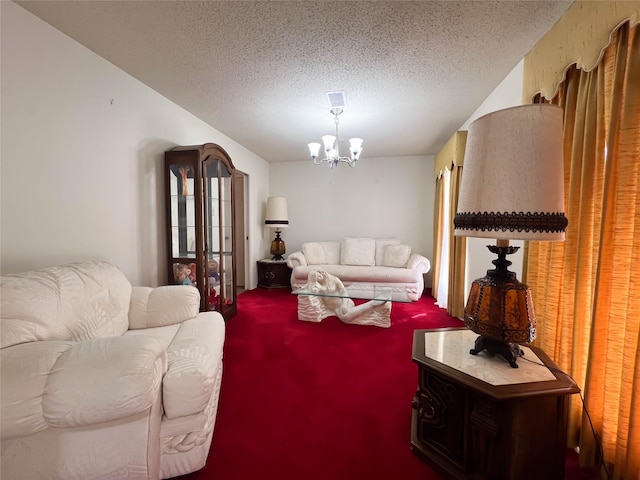 carpeted living room with an inviting chandelier and a textured ceiling