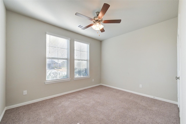 spare room with light colored carpet and ceiling fan