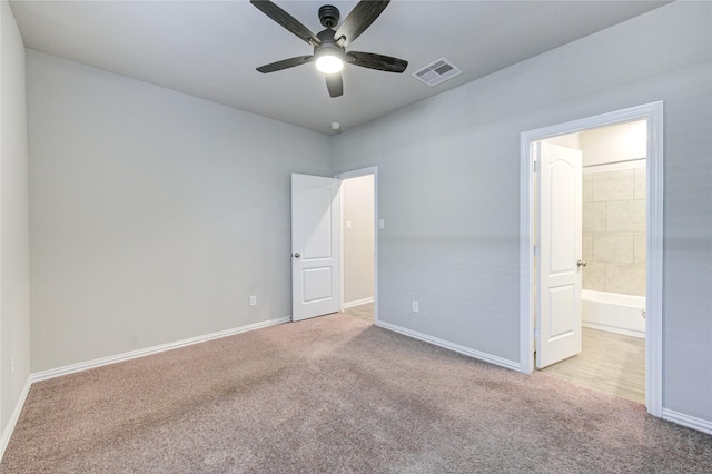 unfurnished bedroom with light carpet, connected bathroom, and ceiling fan