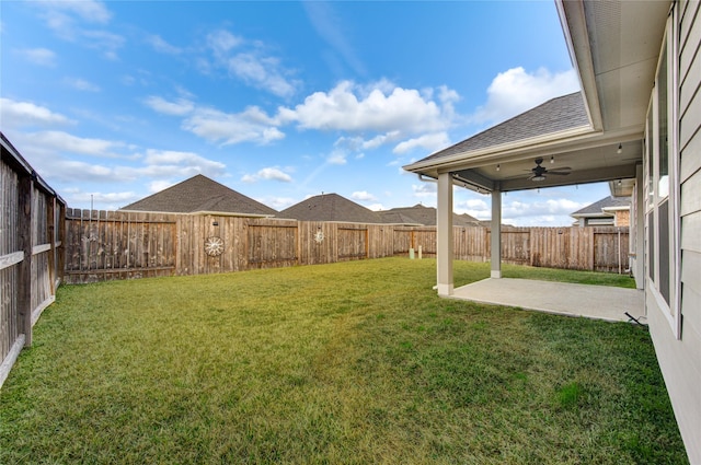 view of yard with ceiling fan and a patio area