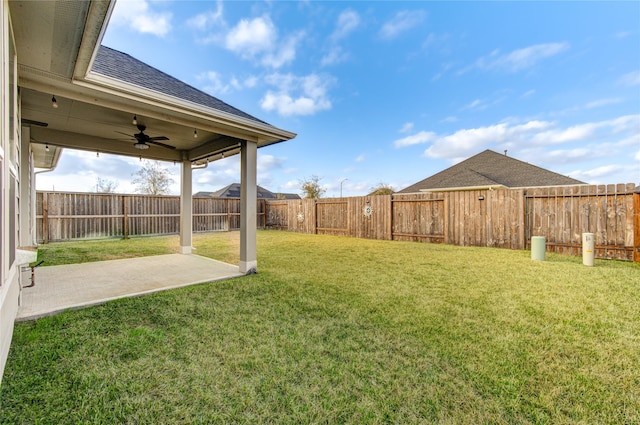 view of yard featuring a patio area and ceiling fan