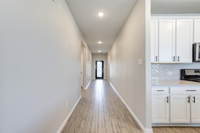 hall with light hardwood / wood-style floors