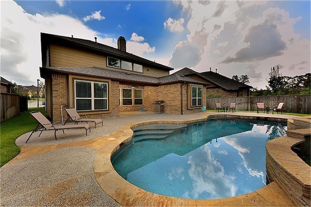 view of swimming pool featuring a grill and a patio area