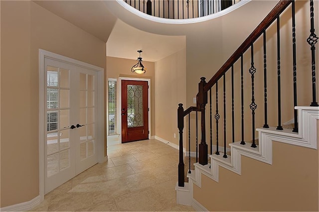 foyer featuring a high ceiling and french doors