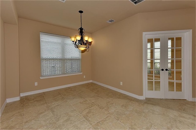 unfurnished room with an inviting chandelier, lofted ceiling, and french doors