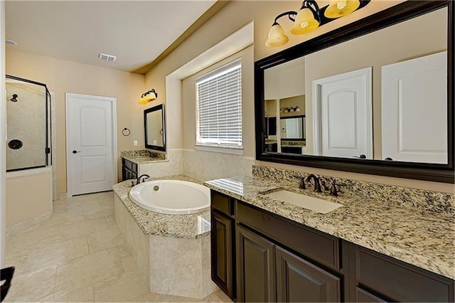 bathroom featuring vanity and independent shower and bath