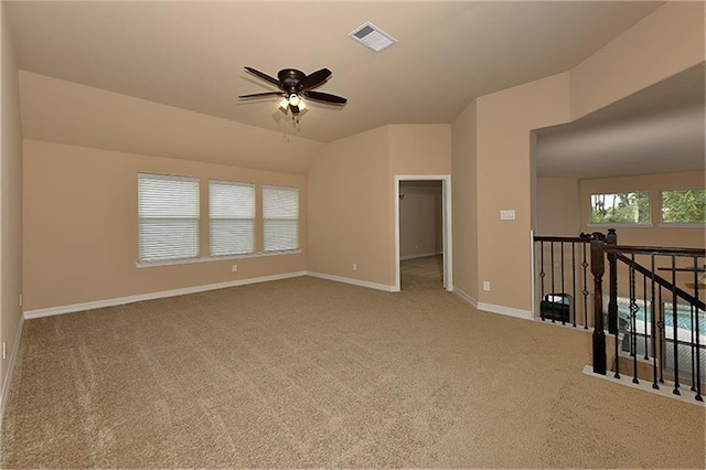 unfurnished room featuring lofted ceiling, carpet flooring, and ceiling fan