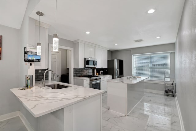 kitchen with sink, decorative light fixtures, kitchen peninsula, stainless steel appliances, and white cabinets